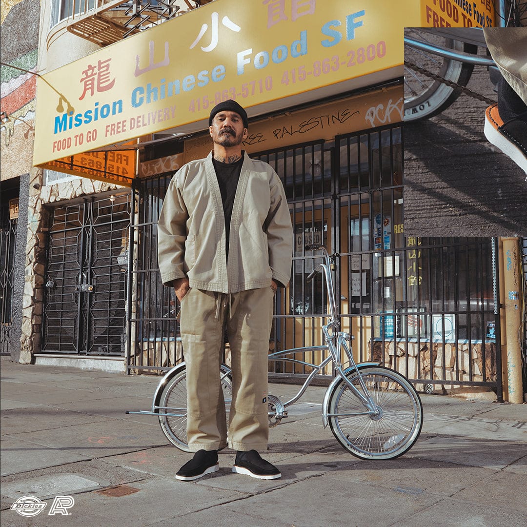 Model wearing sand kimono jacket and gi pants with chrome bicycle in San Francisco