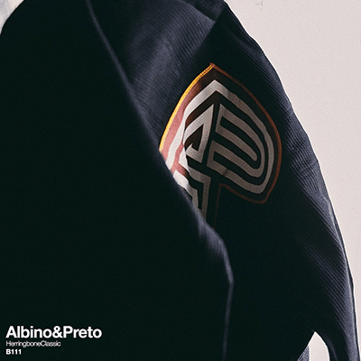 Albino and Preto B111 black gi close up with shoulder patch and herringbone texture